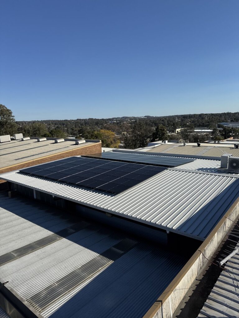 All-black solar panels installed on a commercial metal roof in NSW